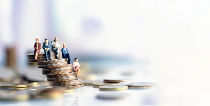 Miniature people sitting on pension savings