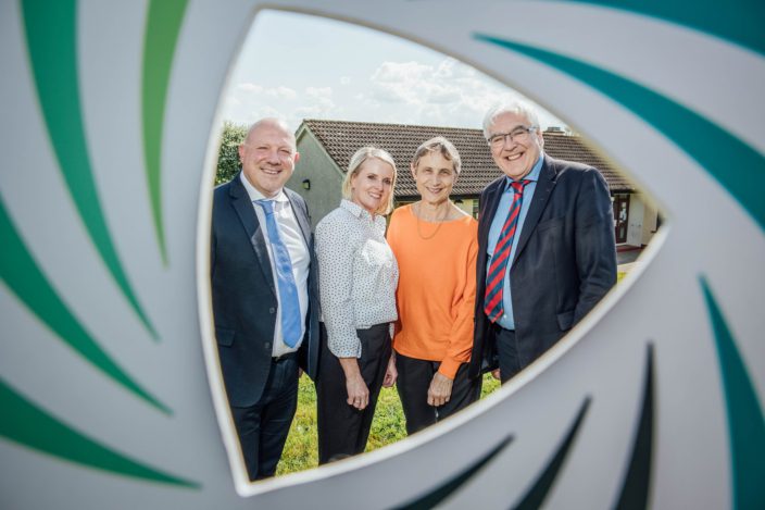 A second image of the four people at the announcement.