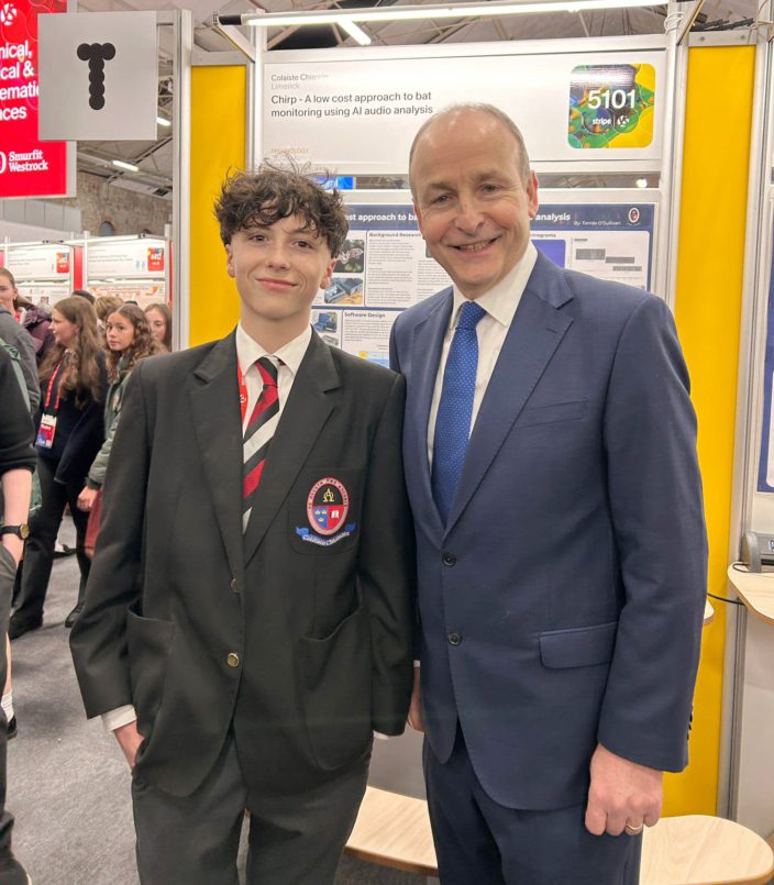 Tomás O’Sullivan, Coláiste Chiaráin, Croom, who won 1st place in the Junior Technology category for Chirp, a low-cost AI tool used to monitor bats being congratulated by Taoiseach Micheál Martin on his win.