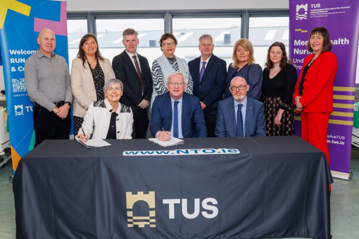 Picture of the agreement being signed by the parties in the partnership